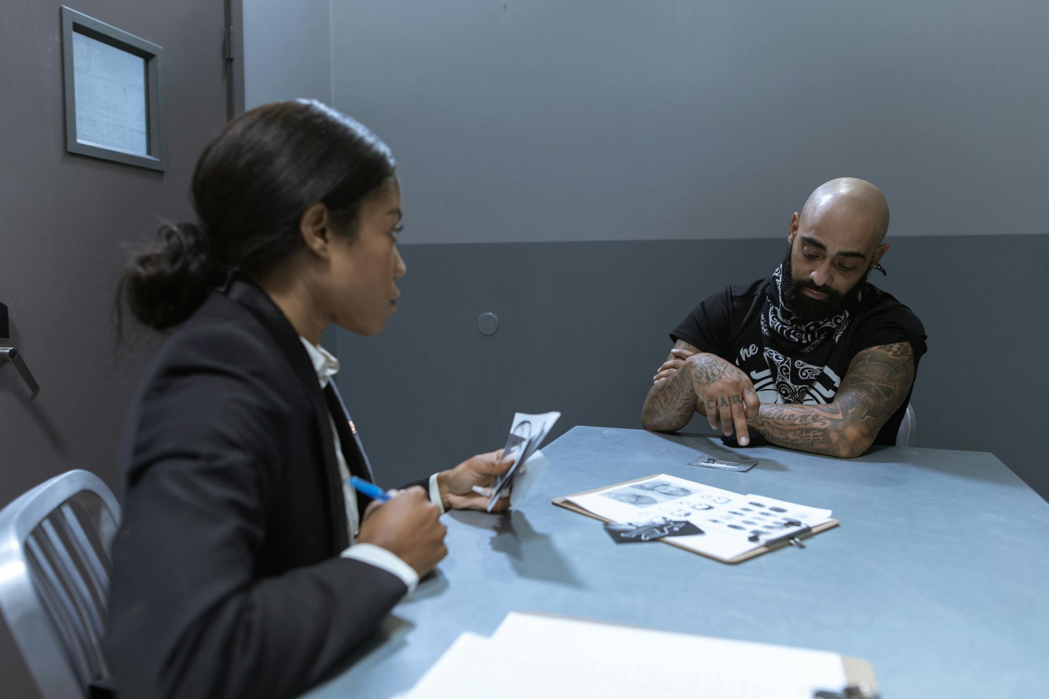 A Detective Talking to a Person in Handcuffs