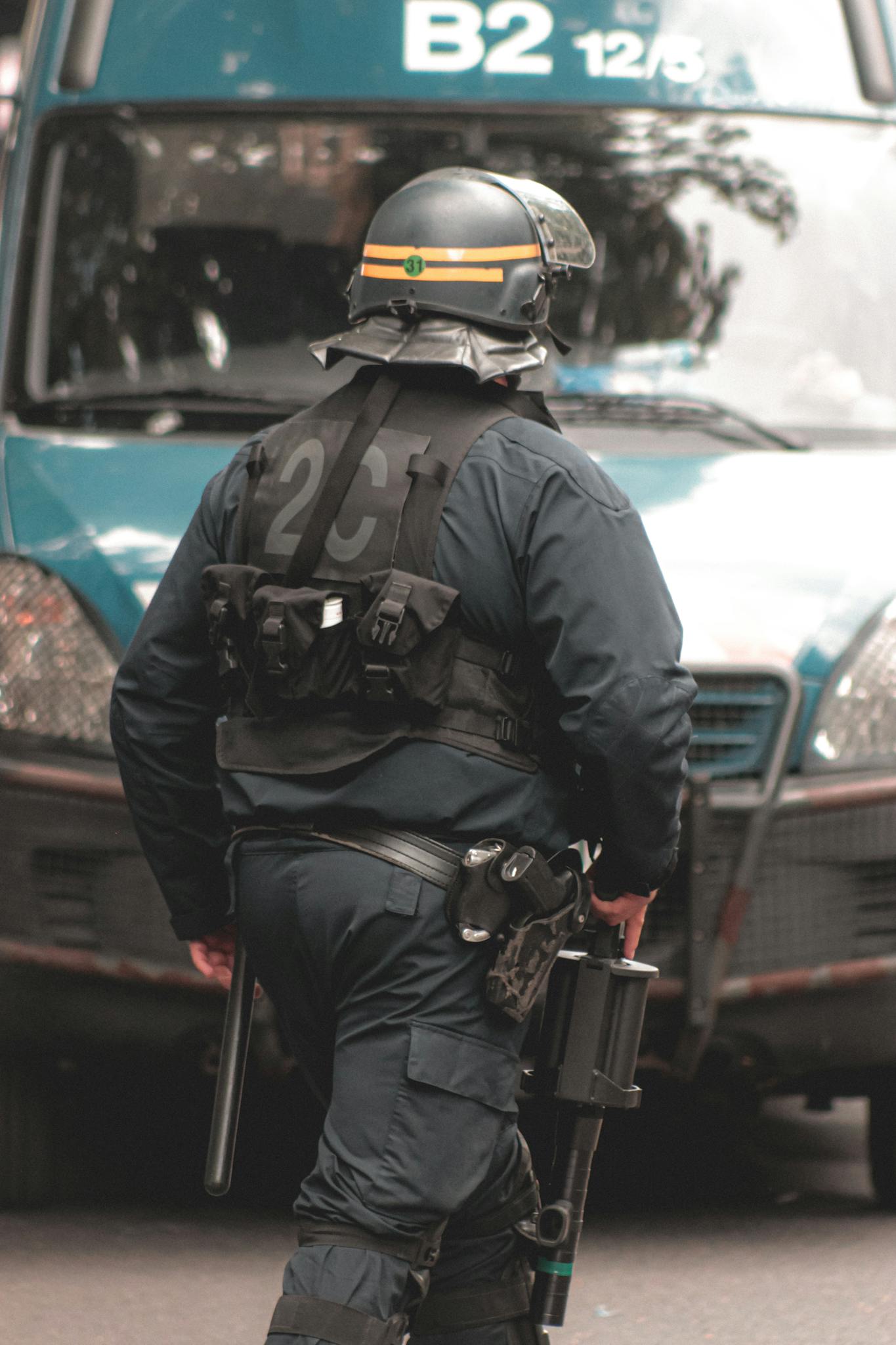 Police officer in helmet and protective vest